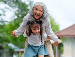 A grandmother plays with her grandchild.