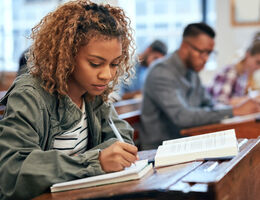 A student taking notes in class.