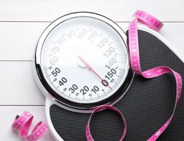 A weighing scale and body tape measure.